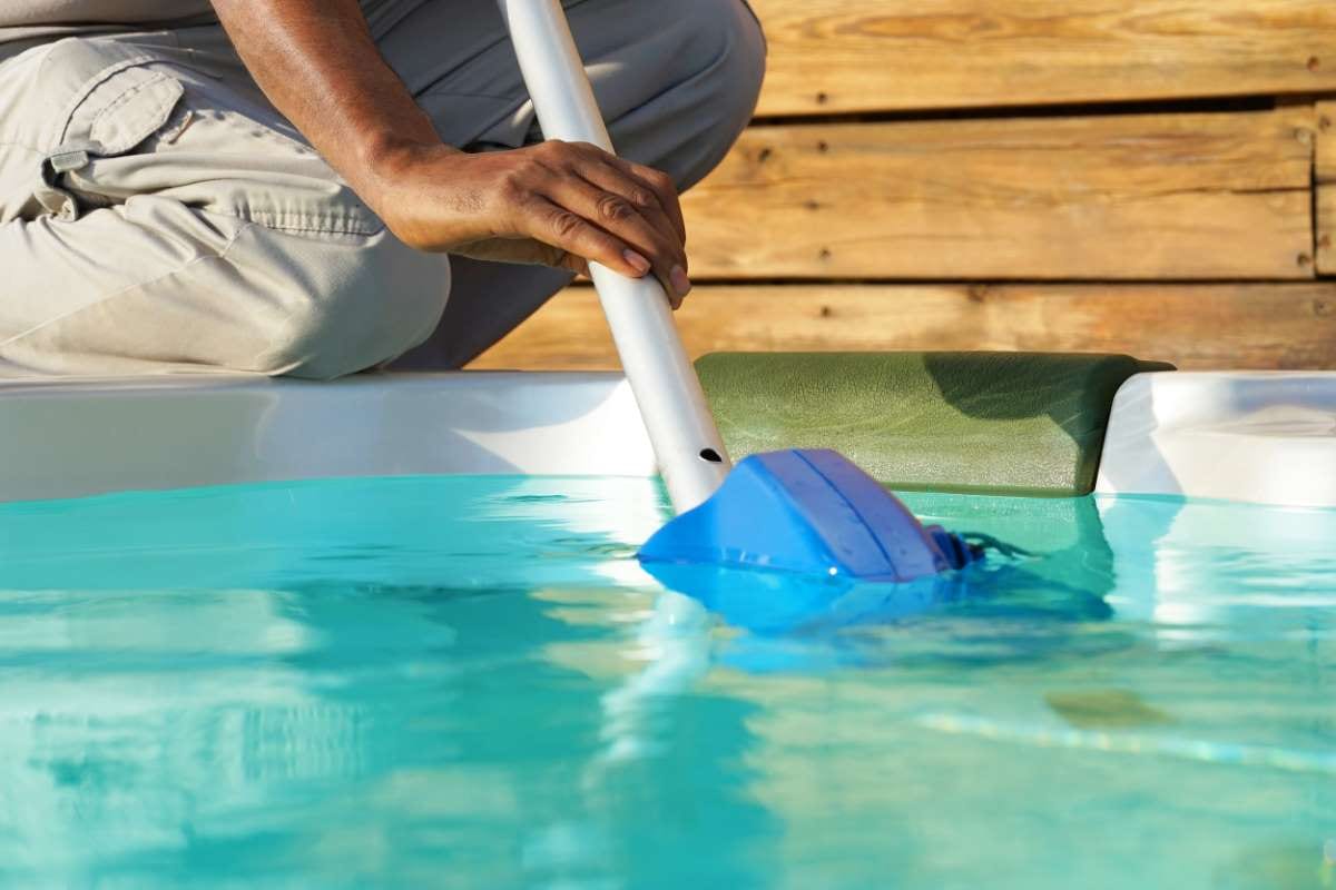 African hotel staff worker cleaning a pool, relevant to pool pros business strategy