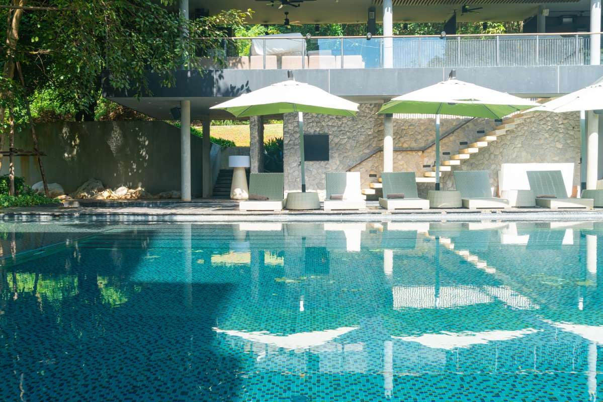 Lounge chairs and umbrella beside a swimming pool at a resort