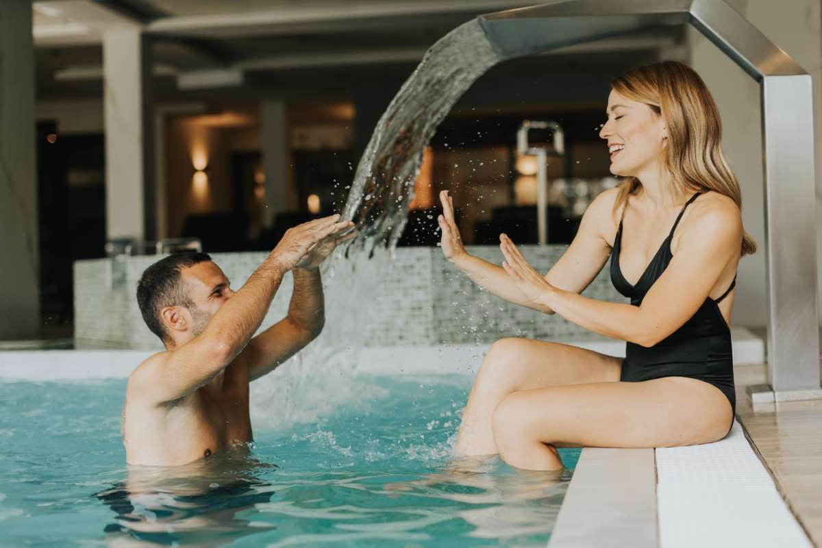 Young couple having fun in an indoor swimming pool