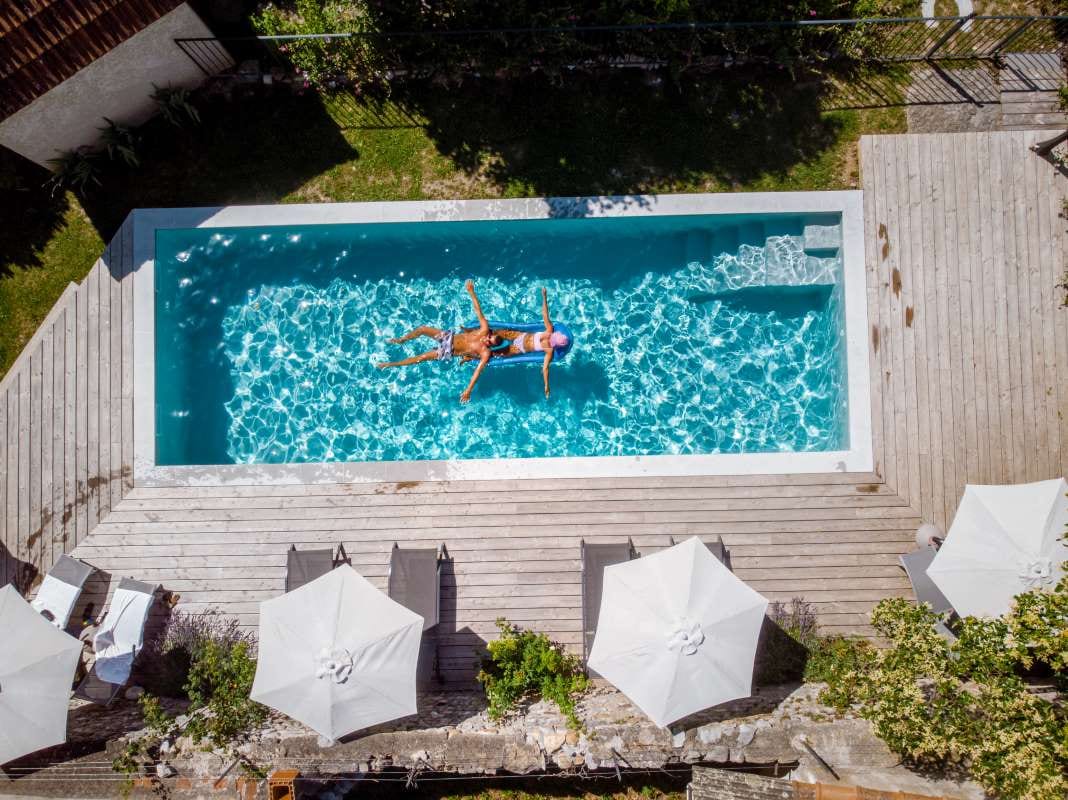 High-angle view of a swimming pool beside lush plants
