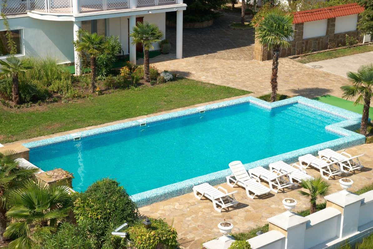 House with a blue pool in the yard