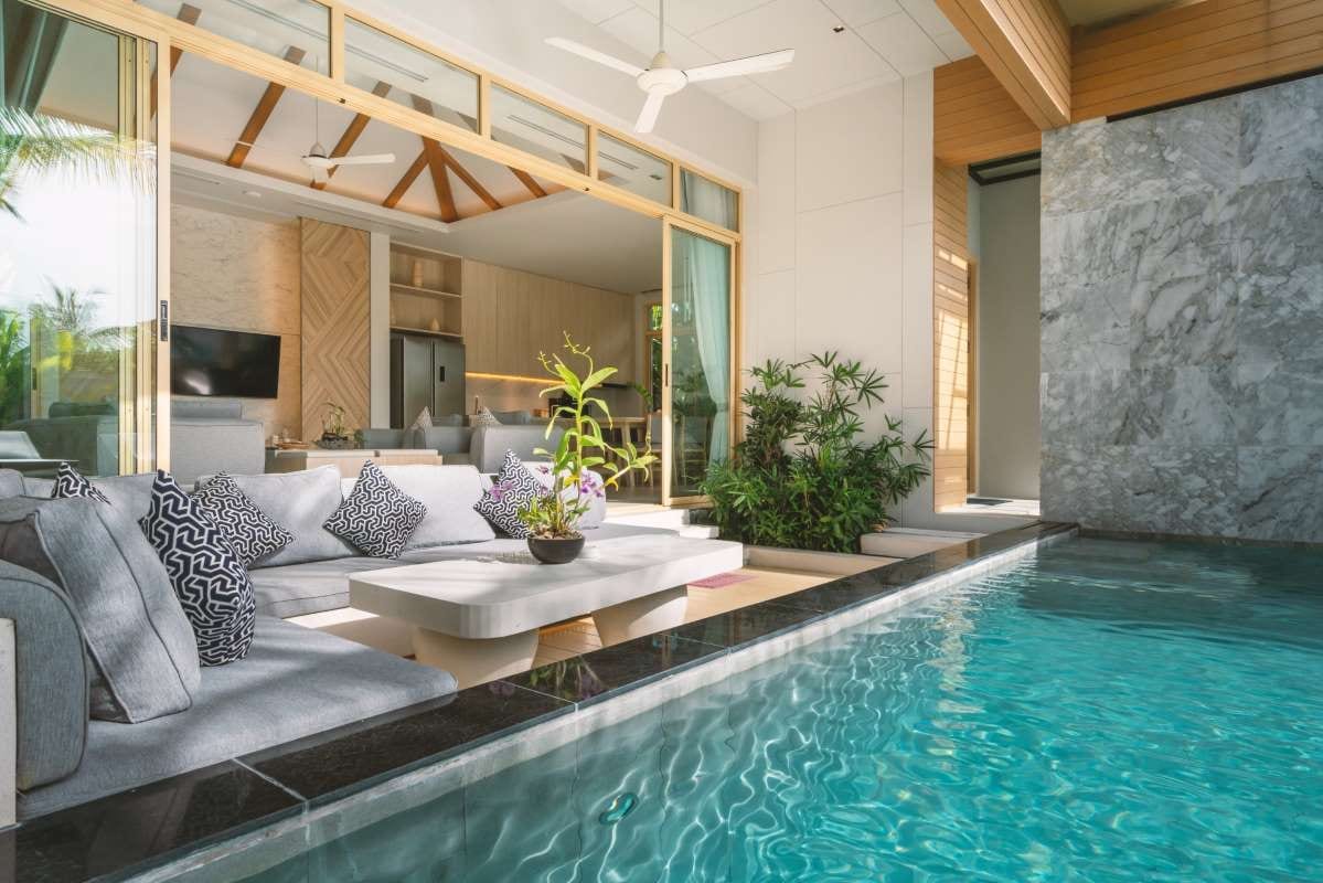 Luxury villa interior with living room opening to a swimming pool