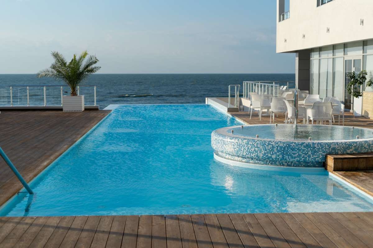 Luxurious modern villa with pool by the sea, evoking success and vacation living