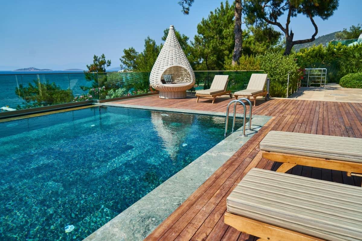 Luxury hotel pool with lounge chairs and tranquil landscaped surroundings