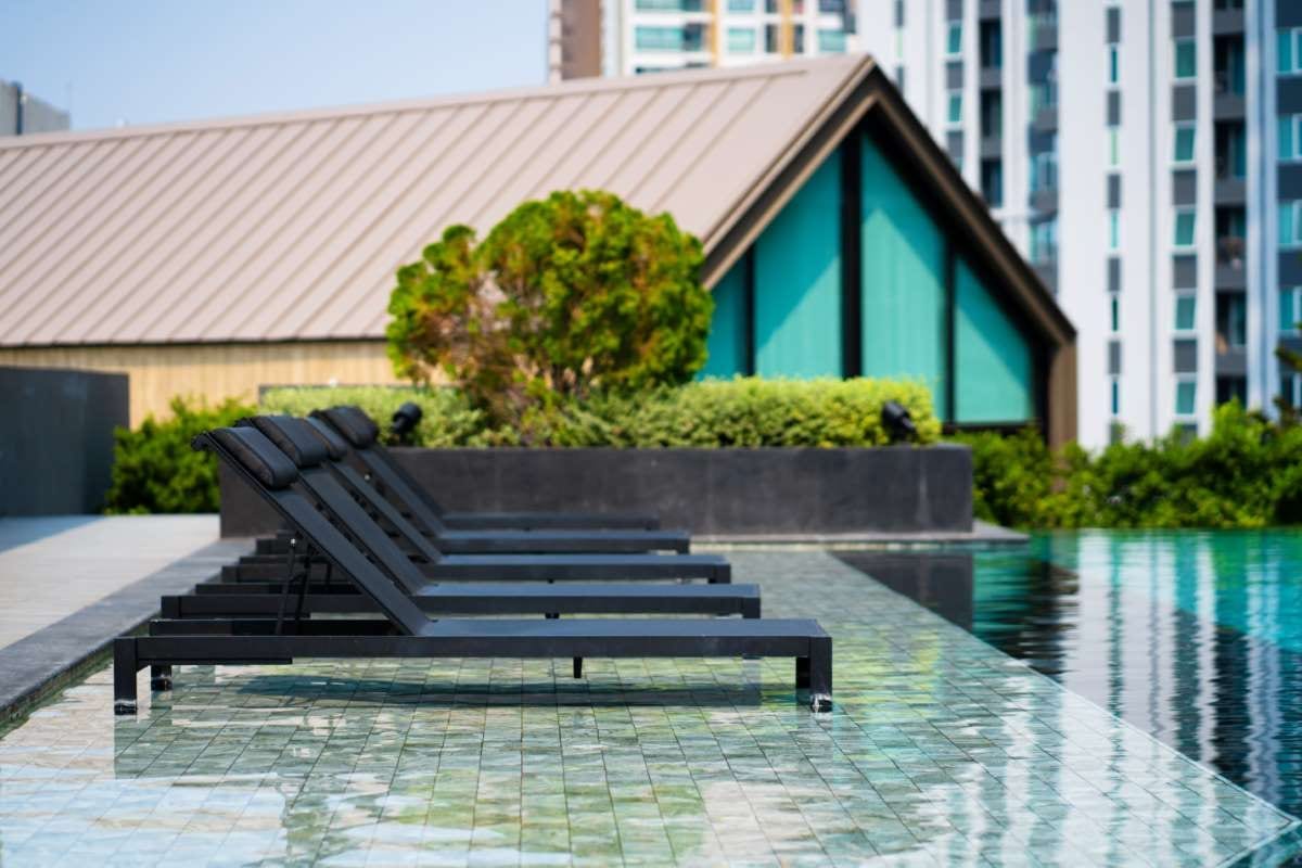 Modern condominium recreation area with swimming pool and lounge space