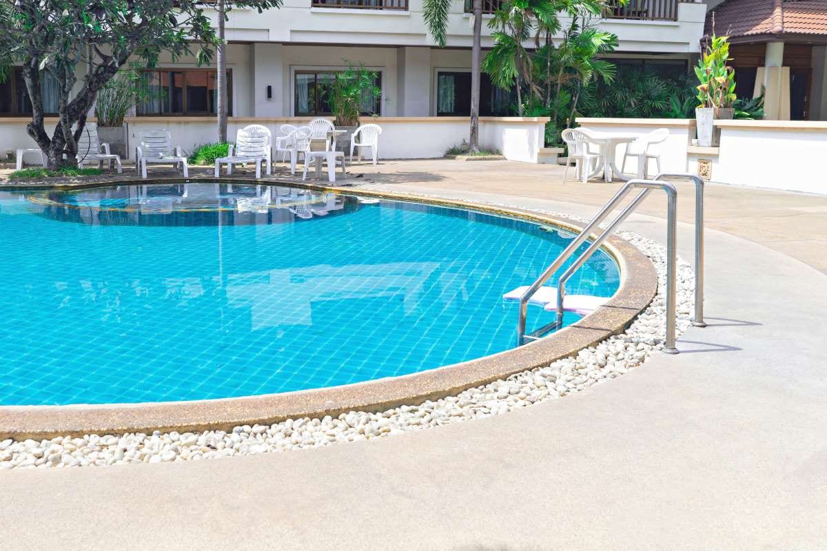 Swimming pool with grab bars and ladder for safe access